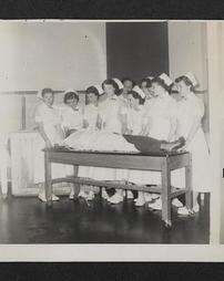 Group of nurses observing a patient on an operating table