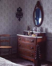 Dresser and Oval Mirror in Bedroom in Maple Manor
