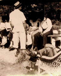 Group with man in wicker chair