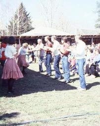 Two Lines of Square Dancers With Crowd on Lawn