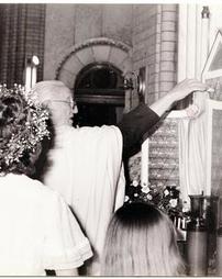 Priest praying to the Virgin Mary at Sts. Casimir and Emerich Church
