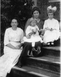 Four people on porch steps