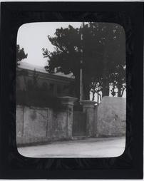Bermuda Islands. [View of wall and gate with trees and house]