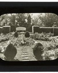 United States. [Unidentified Flower Beds, Sundial, Hedge]