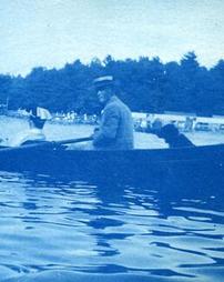 Two women, a man, and a dog in a boat