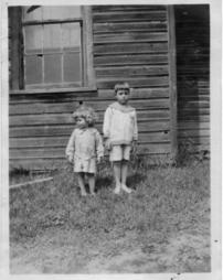 Billy Thomas Bungard and Jimmie Bungard standing barefoot in the grass