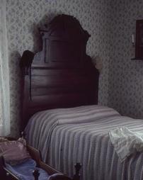 Bed and Cradle in Bedroom at Maple Manor