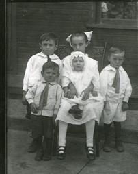 Children with baby in christening gown
